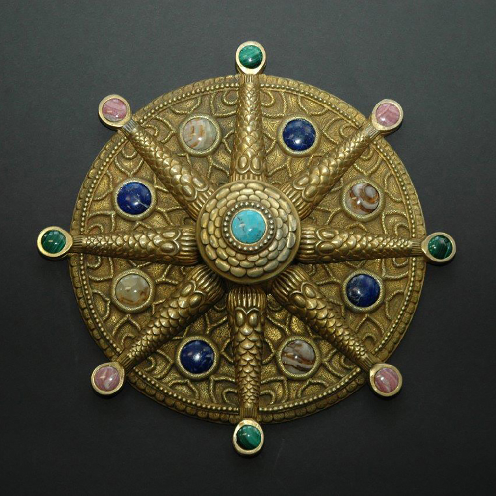Large demi-lune plates and door pulls with studded with semi-precious stones.